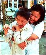 Dr. Nguyen Thi My Hien with an Agent Orange victim