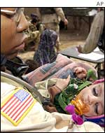 US soldier cradles a malnourished infant during a humanitarian aid medical mission in Makwan Afghanistan