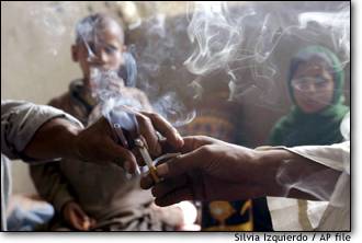 Image: Kabul residents share an opium cigarette
